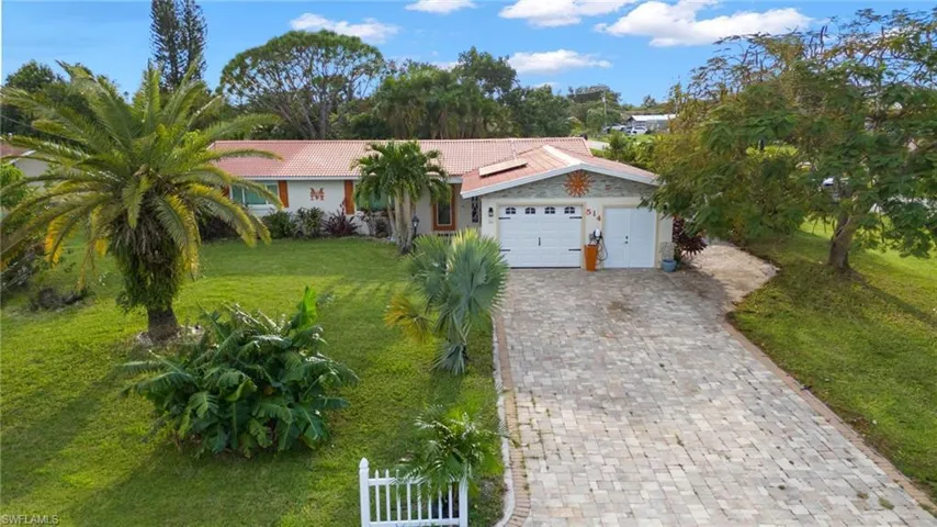 Ranch-style house with a front lawn and a garage