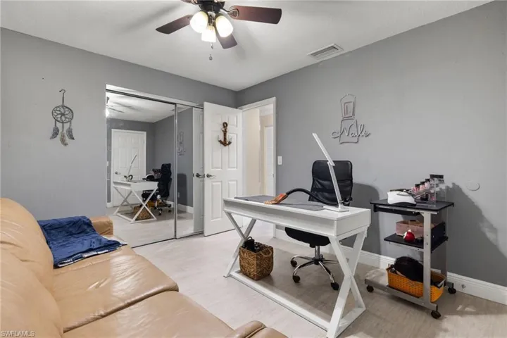 Office area with light hardwood / wood-style flooring and ceiling fan