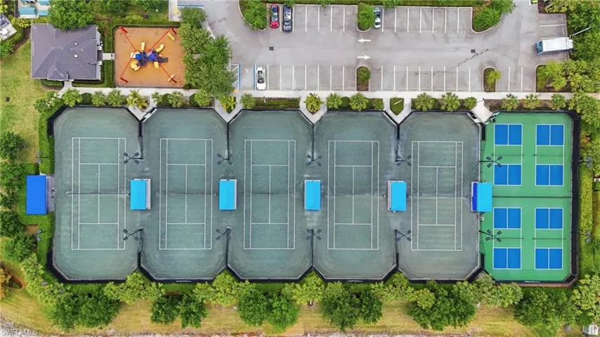 Community recreational area featuring multiple tennis courts, pickleball courts, and a playground