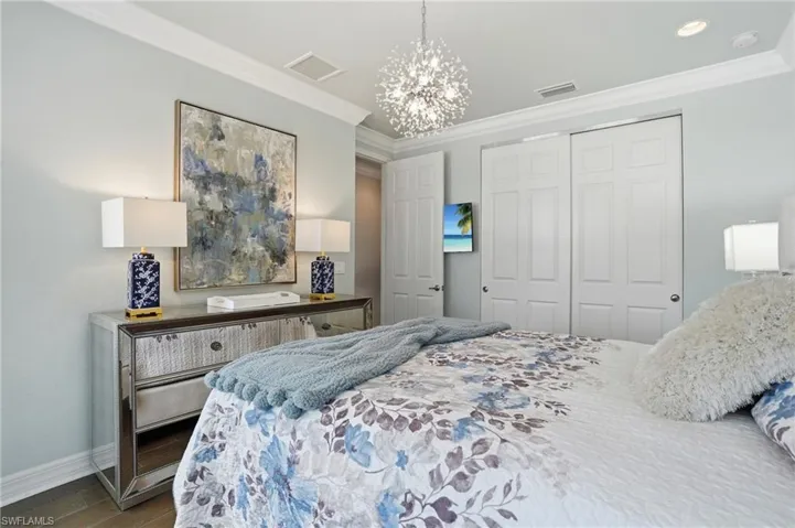 Recessed lighting and crown molding accentuate the interior space, featuring wood-finish flooring