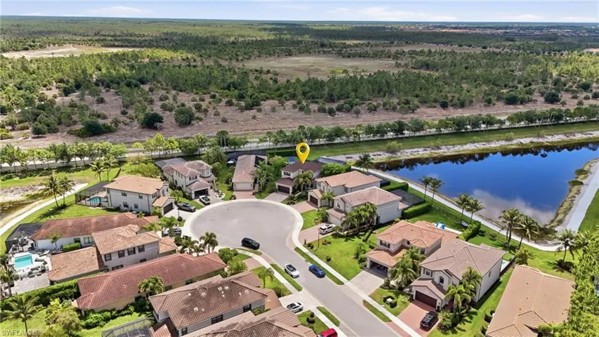 Aerial perspective of a residential cul-de-sac community with a primary property marked by a location pin