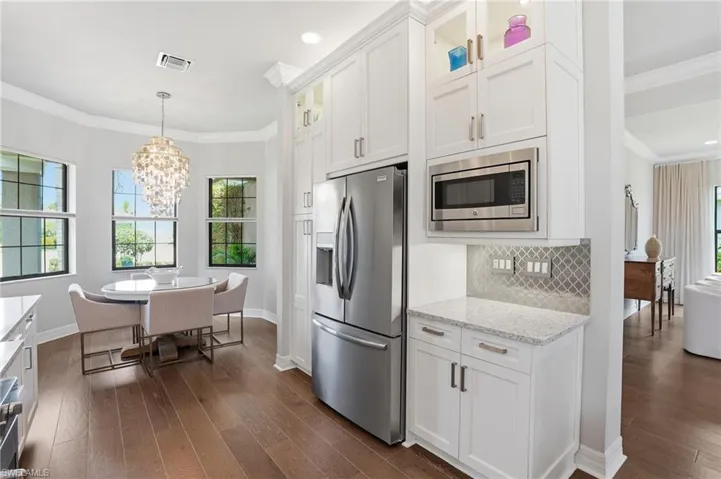 Integrated kitchen and dining area featuring wood-finish flooring
