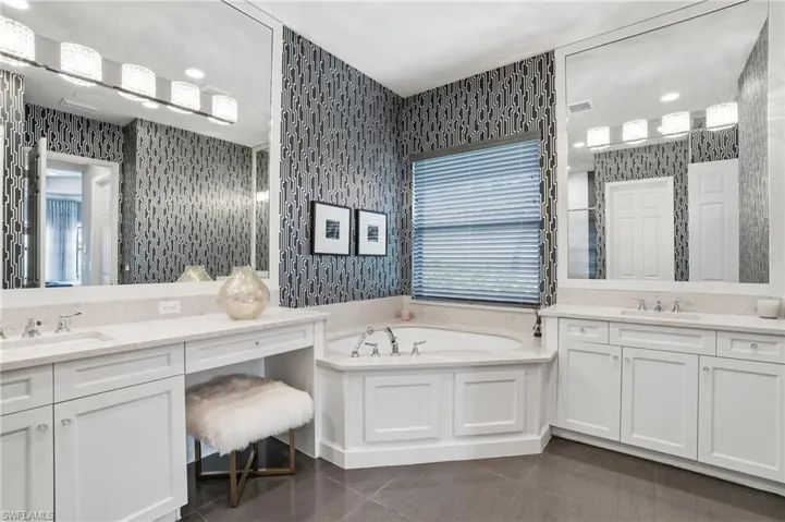 Dual vanity sinks with white cabinetry and light-toned countertops