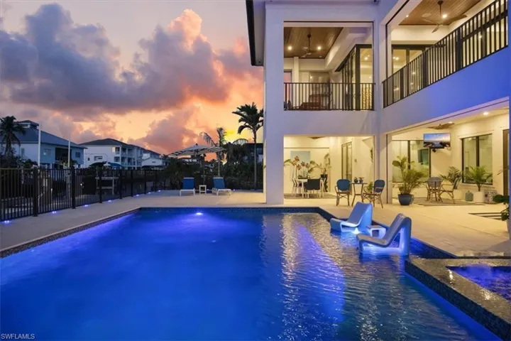 View of swimming pool featuring a fenced in pool, a patio area, fence, and an outdoor hot tub
