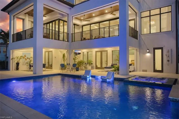 View of swimming pool with a patio, ceiling fan, and a pool with connected hot tub
