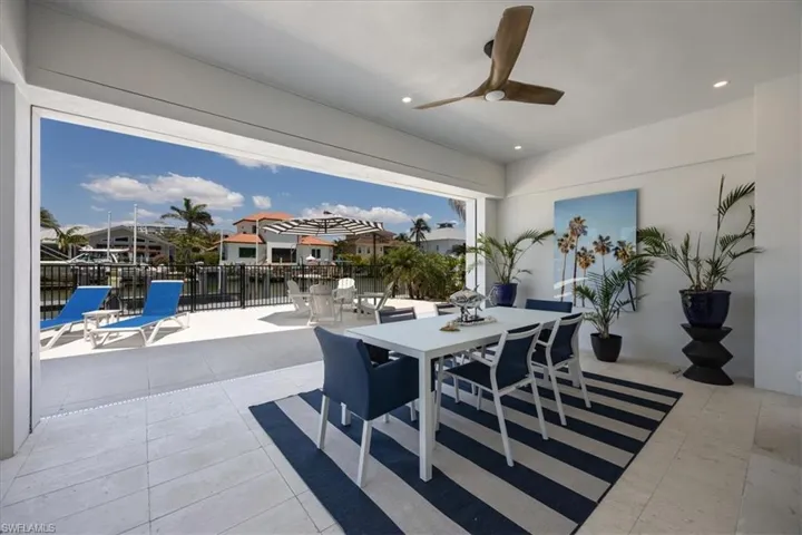 Tiled dining space featuring a ceiling fan, recessed lighting, and a residential view