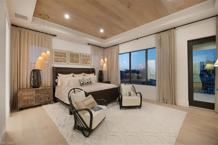 Bedroom featuring visible vents, wood finished floors, recessed lighting, wood ceiling, and a tray ceiling