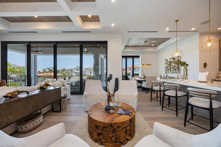 Living area with recessed lighting, beam ceiling, light wood-style flooring, and coffered ceiling