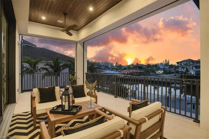 View of patio featuring a water view, ceiling fan, a balcony, and an outdoor hangout area