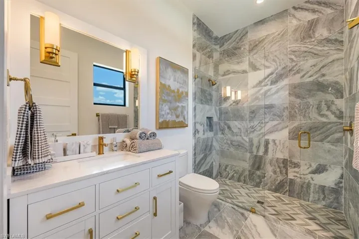 Full bath with vanity, recessed lighting, a stall shower, and toilet