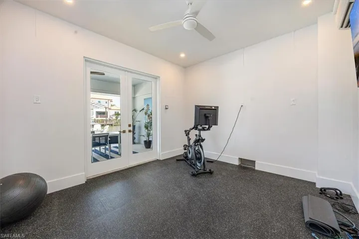 Workout area with french doors, ceiling fan, and recessed lighting