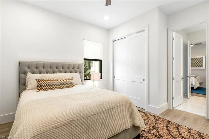Bedroom featuring wood finished floors, a closet, a ceiling fan, and recessed lighting