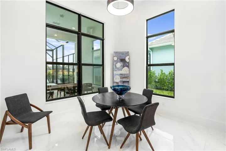Dining space featuring marble finish flooring