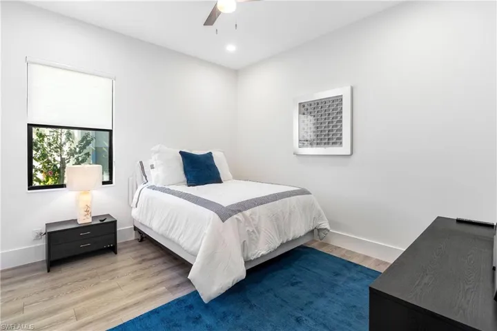 Bedroom with wood finished floors, ceiling fan, and recessed lighting