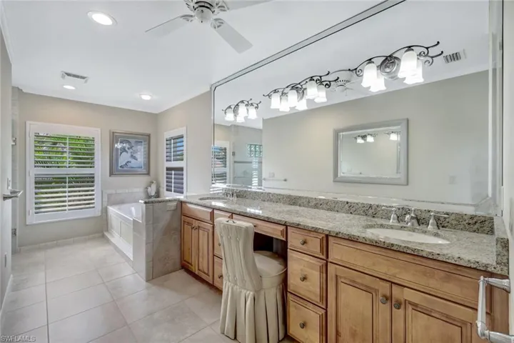 Expansive primary bathroom with soaking tub and dual sinks.