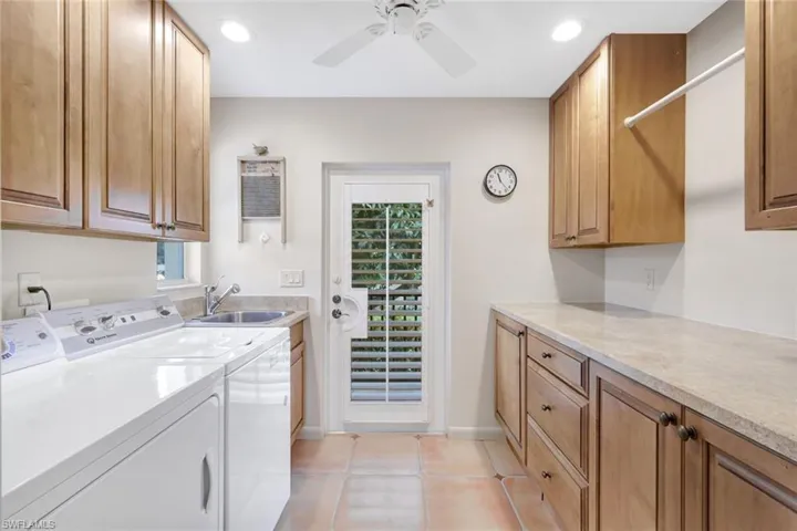 Laundry room provides ample storage space and pool access.
