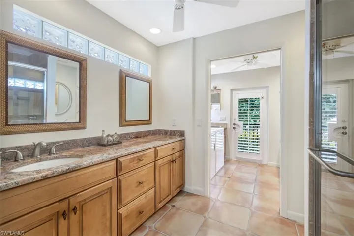 Pool bath is located just past the wet bar  with a walk-in shower.