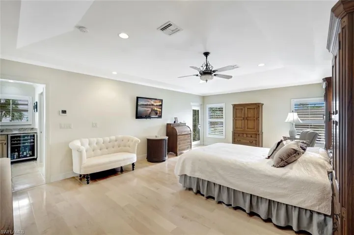 Stunning primary bedroom suite with access to the pool.