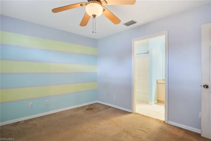 Carpeted spare room with ceiling fan