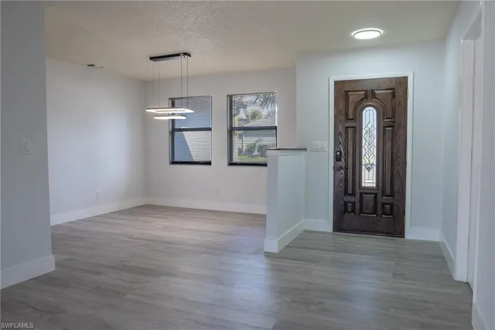 Entryway featuring a textured ceiling and light hardwood / wood-style floors