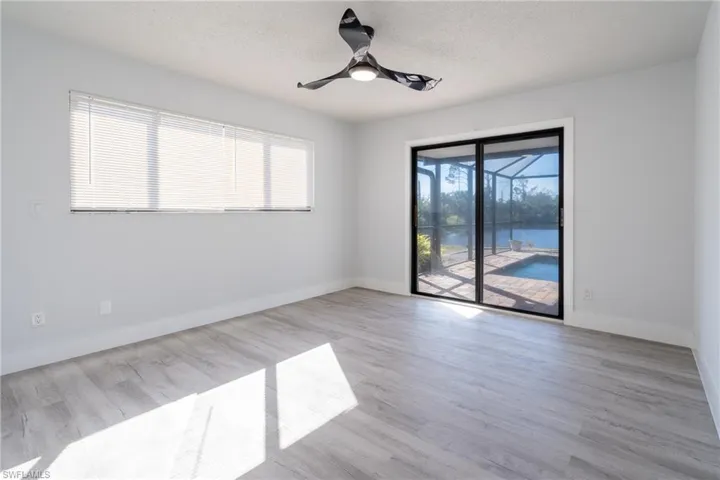 Primary Bedroom  with a textured ceiling, ceiling fan, and light hardwood / wood-style flooring