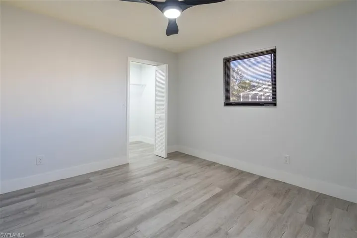 Guest room featuring ceiling fan and light hardwood / wood-style floors
