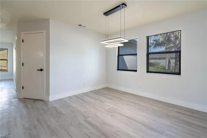 Dining room featuring a textured ceiling and light wood-type flooring