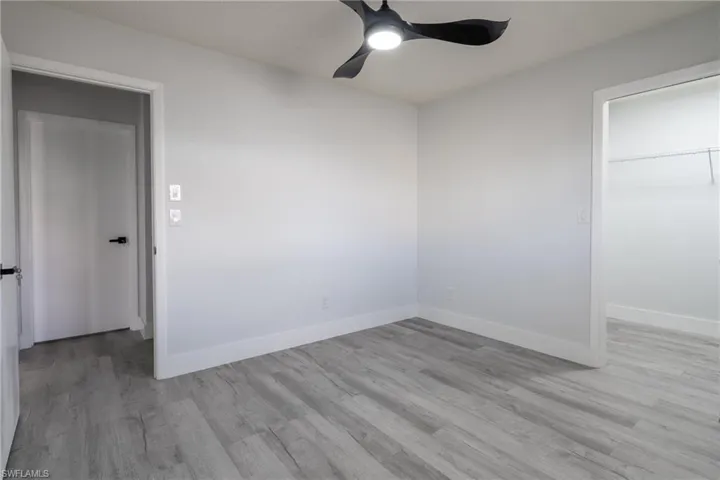 Guest room featuring light hardwood / wood-style floors and ceiling fan