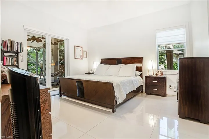 Bedroom with light tile patterned floors and access to outside