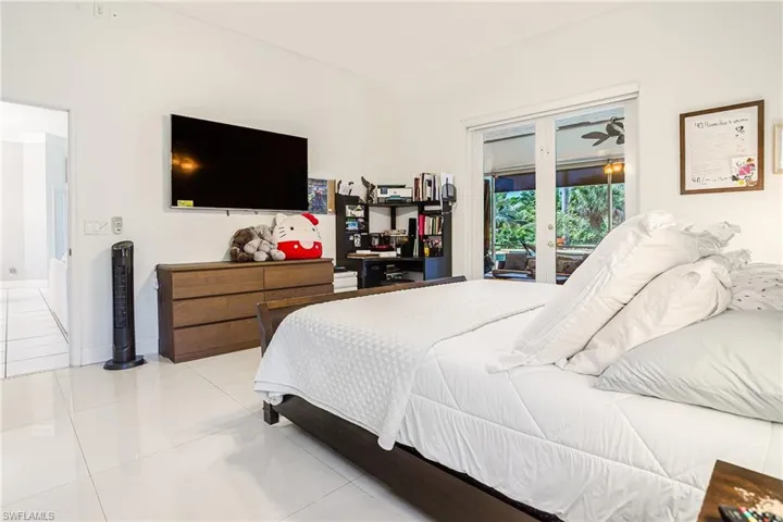 Bedroom with tile patterned floors, access to outside, and french doors