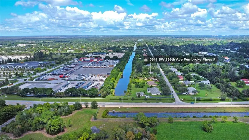 Drone / aerial view of a large body of water and a tree filled landscape