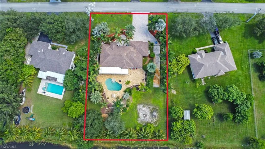 Aerial view of property and surrounding area featuring property parcel outlined