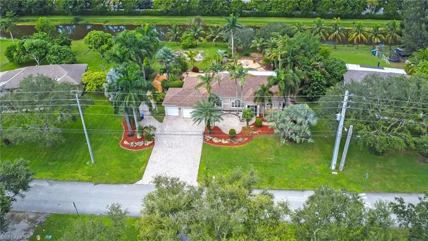 Aerial view of property and surrounding area with a nearby body of water