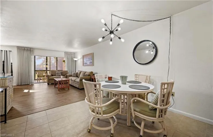 Dining room with light tile patterned floors and a chandelier