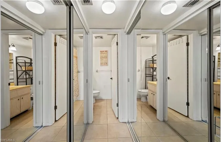 Full bathroom with light tile patterned floors and vanity