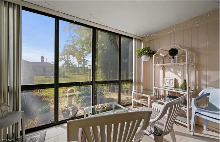 Sunroom / solarium with floor to ceiling windows and tile patterned flooring