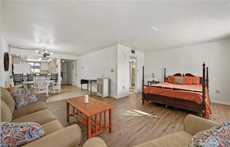 Bedroom with wood finished floors and a chandelier