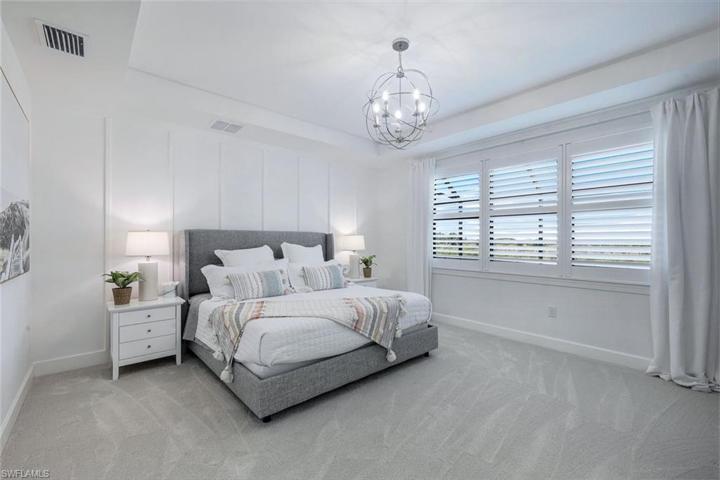 Spacious primary bedroom with tray ceiling, upgraded carpet/padding.