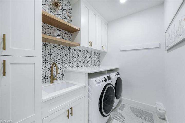 Upgraded appliances in beautiful laundry room.