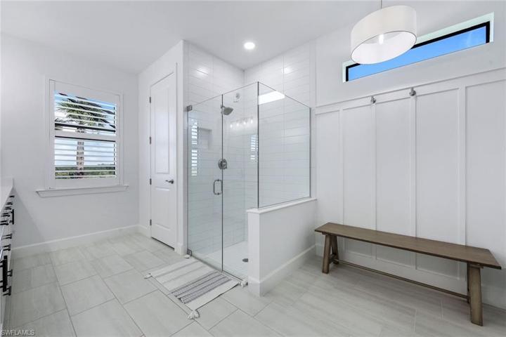 Primary ensuite with dual sinks and gorgeous walk-in closet with custom storage unit.