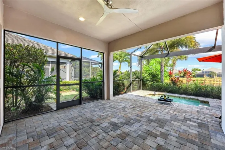Unfurnished sunroom with ceiling fan