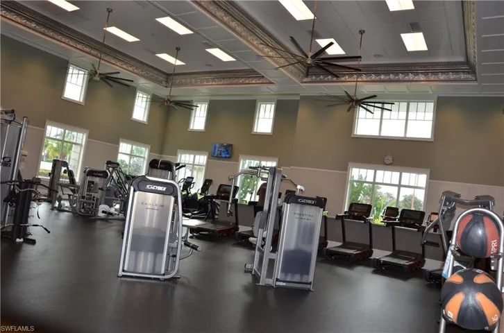 Huge Fitness Center with ceiling fan and a high ceiling