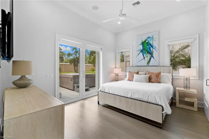 Bedroom featuring ornamental molding, wood finished floors, access to exterior, a ceiling fan, and recessed lighting