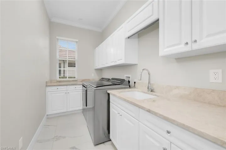 Laundry Room Featuring Cabinet Space, Washer and Clothes Dryer