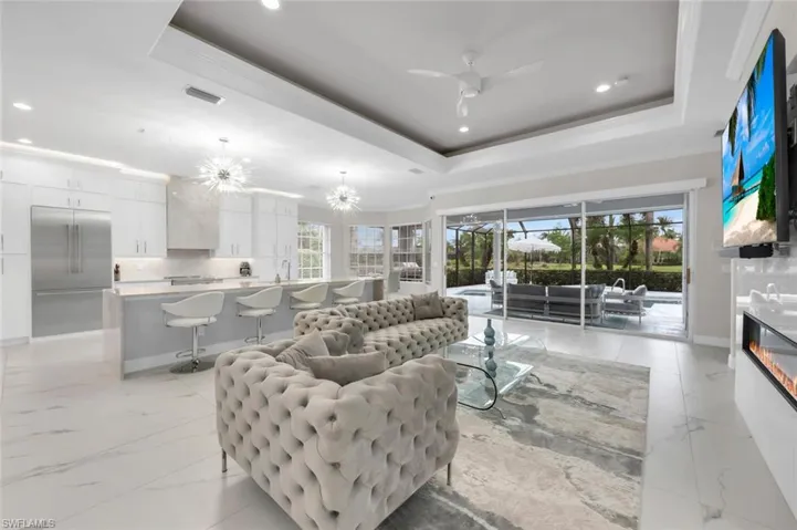 Open Living Area Featuring Tray Ceiling, Ceiling fan,