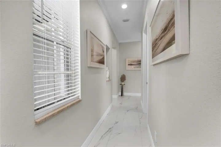 Hallway featuring marble look tiles