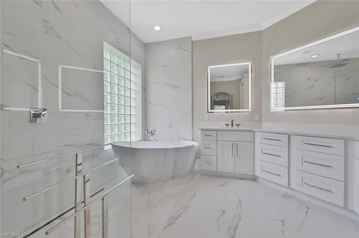 Full Primary Bathroom Featuring a Freestanding Bath Tub