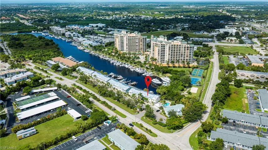 Bird's eye view of numerous boat docks and a nearby body of water