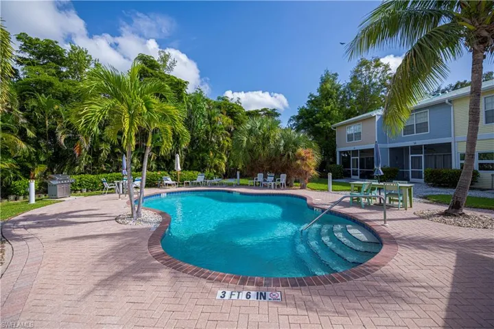 Community pool with a patio area and area for grilling