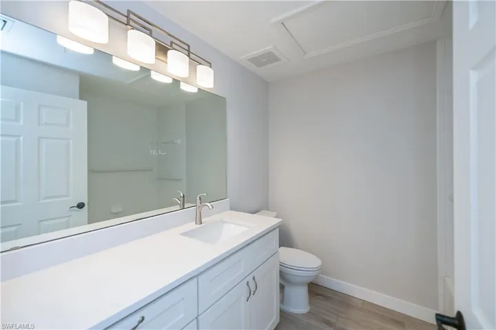 Full bathroom featuring vanity, light wood finished floors, and tub / shower combination